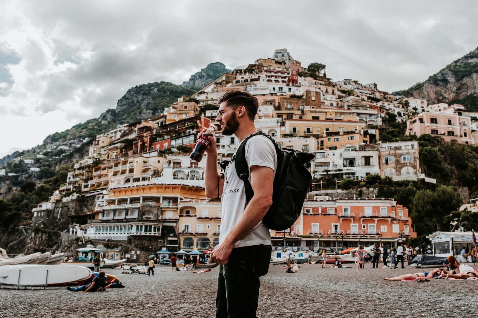 a guy with his backpack is in european town