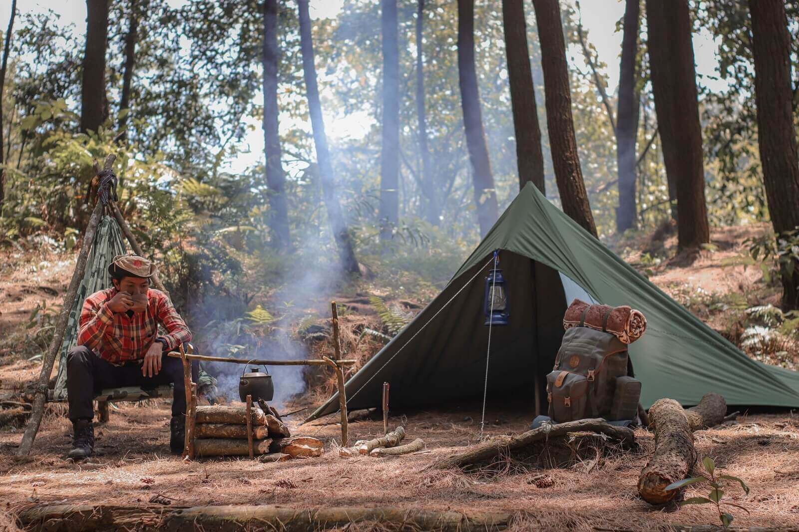 a man is camping in forest