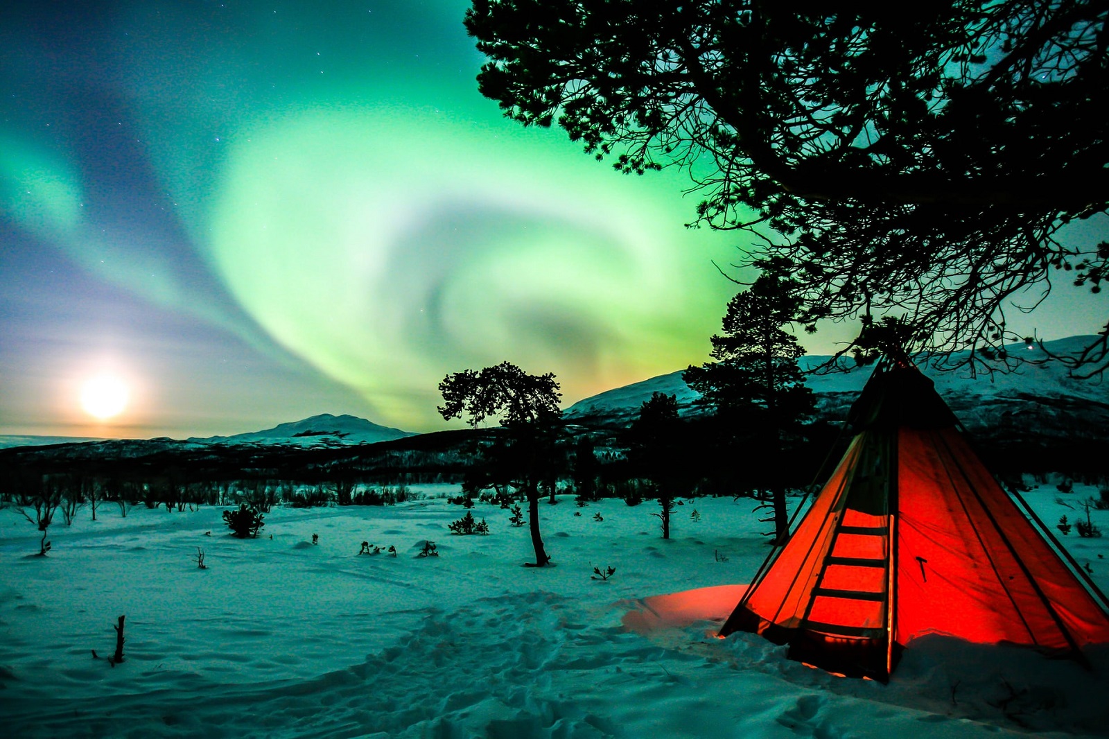 a tent is in snow covered ground