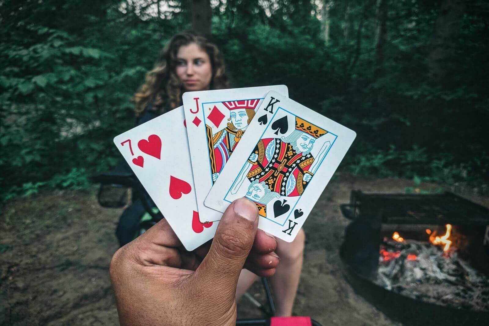 couple is playing cards while camping