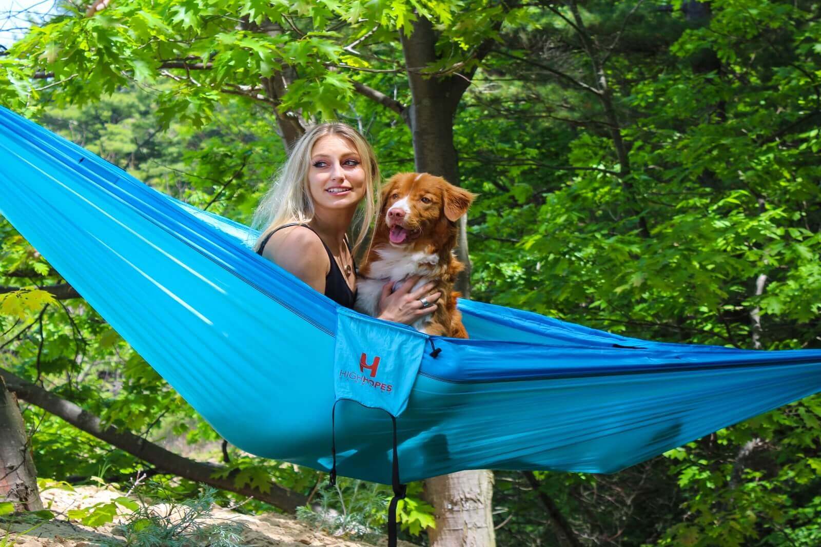 a woman is camping with her dog