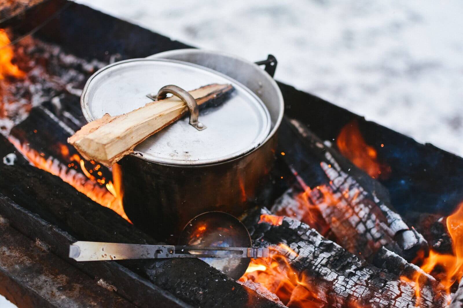 a pot is on camp fire