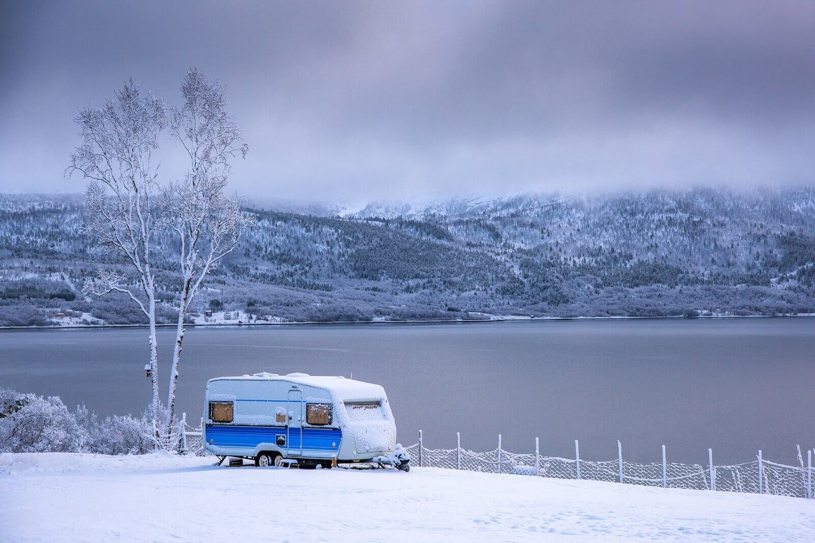 rv is parked on snow covered campground